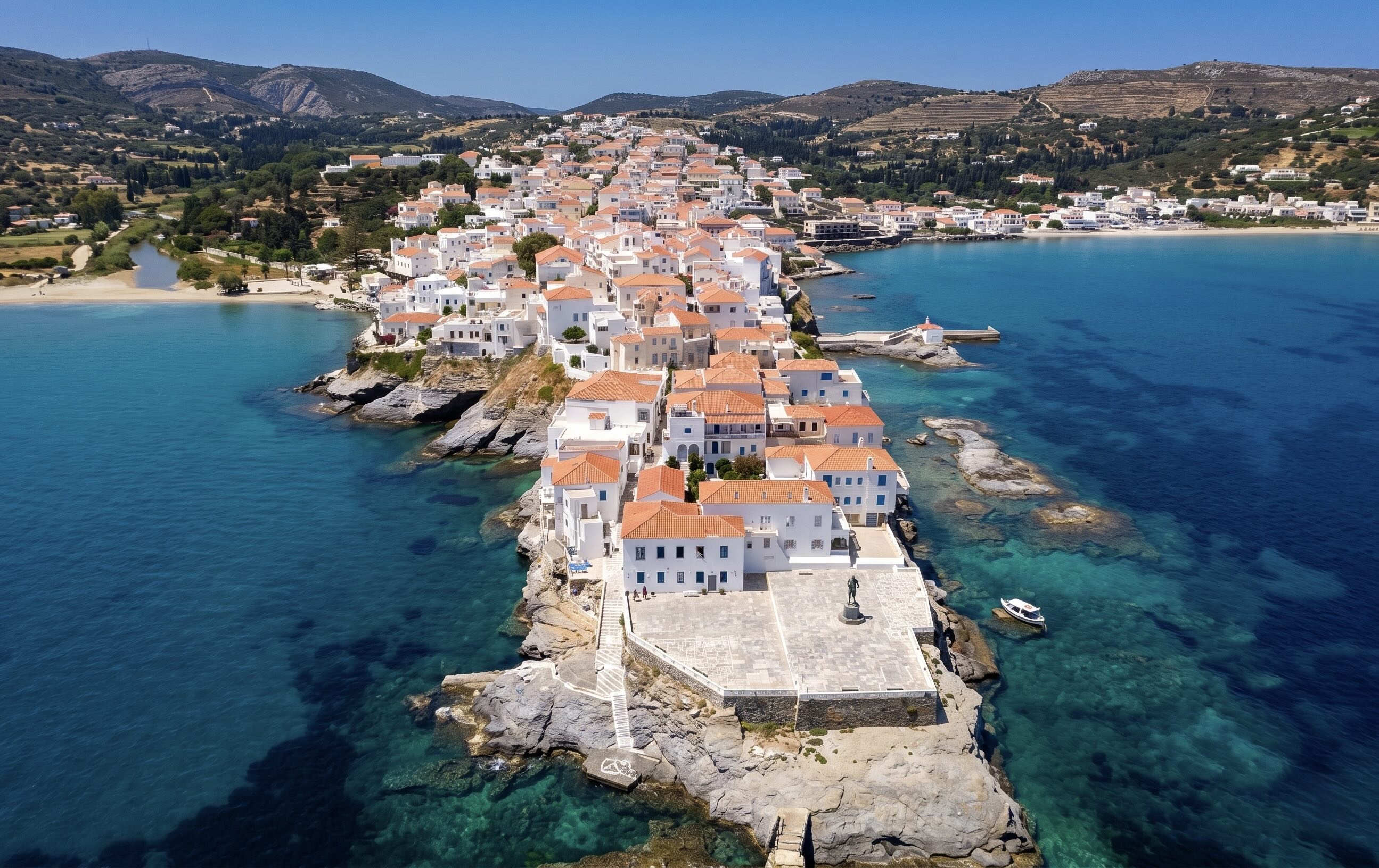 Aerial view of Andros Town peninsula surrounded by turquoise sea