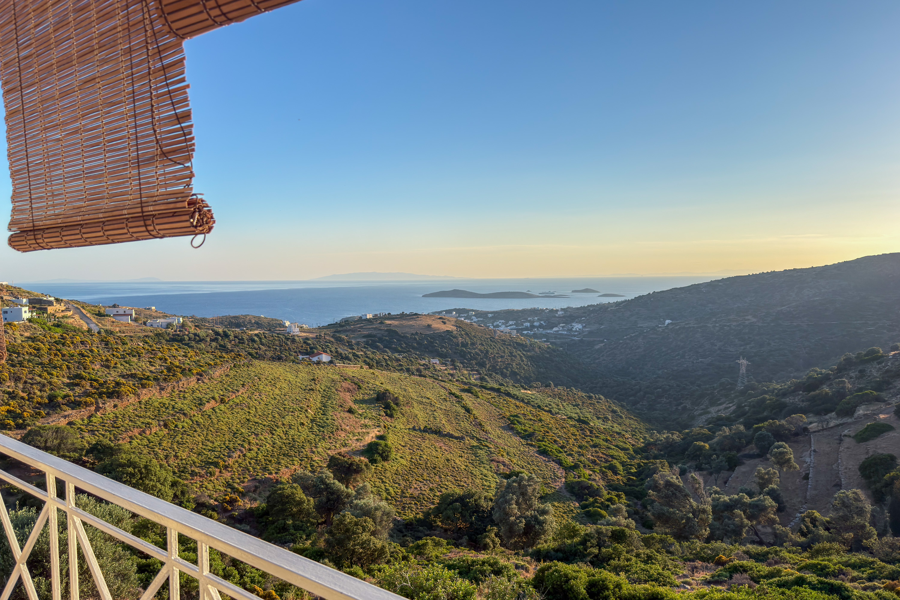 105 Anatolika Residence balcony panoramic view across Andros hills to the Aegean Sea at dusk